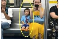 地铁上一对母子的照片引网友热议：是有教养，却失去了童真？